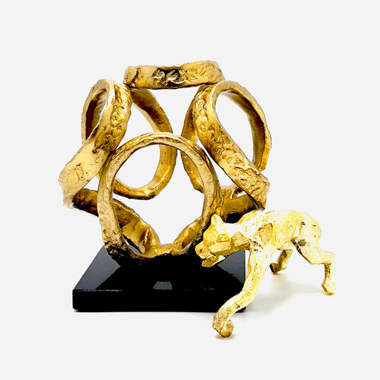 Golden Knot sculpture on a black granite base